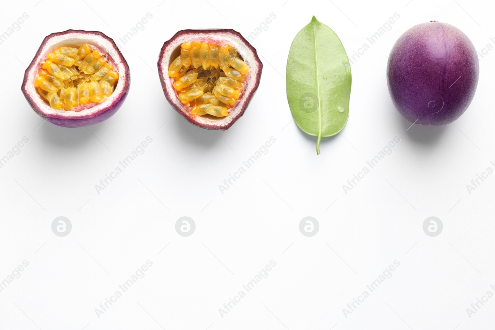 Photo of Fresh passion fruits with green leaf on white background, flat lay. Space for text