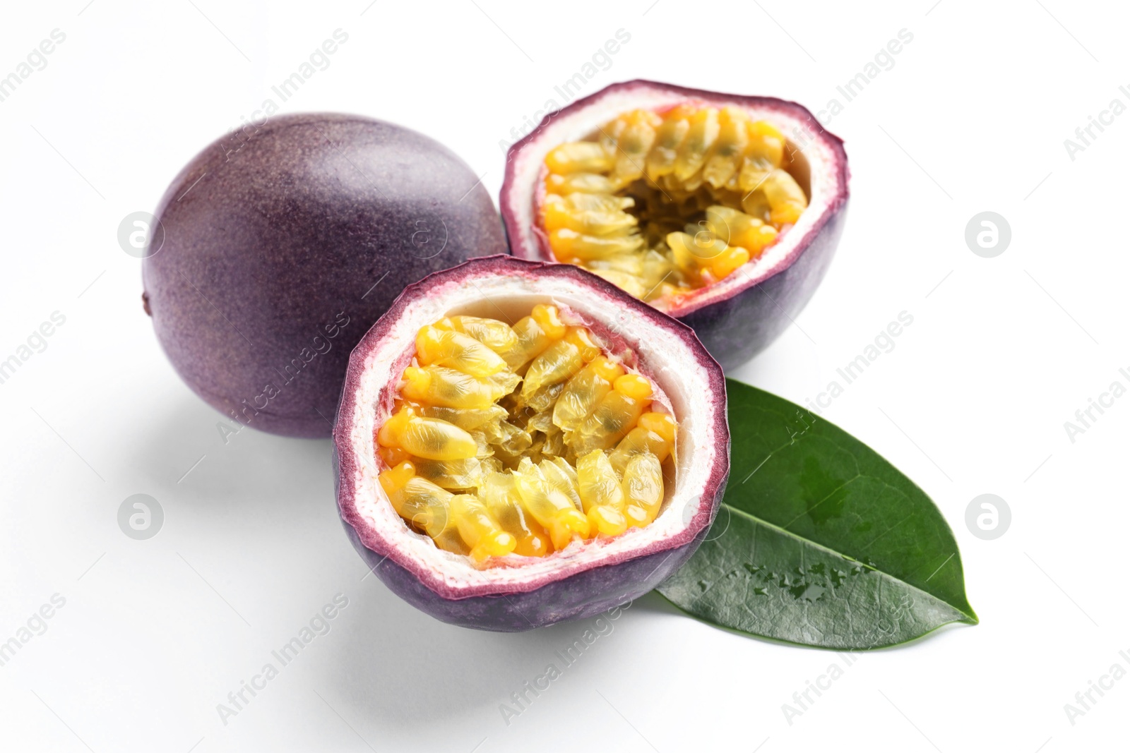 Fresh passion fruits with green leaf on white background, closeup Photo of Fresh passion fruits with green leaf on white background, closeup