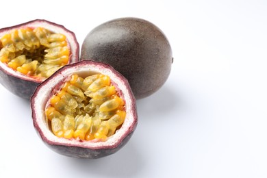 Photo of Fresh passion fruits on white background, closeup. Space for text