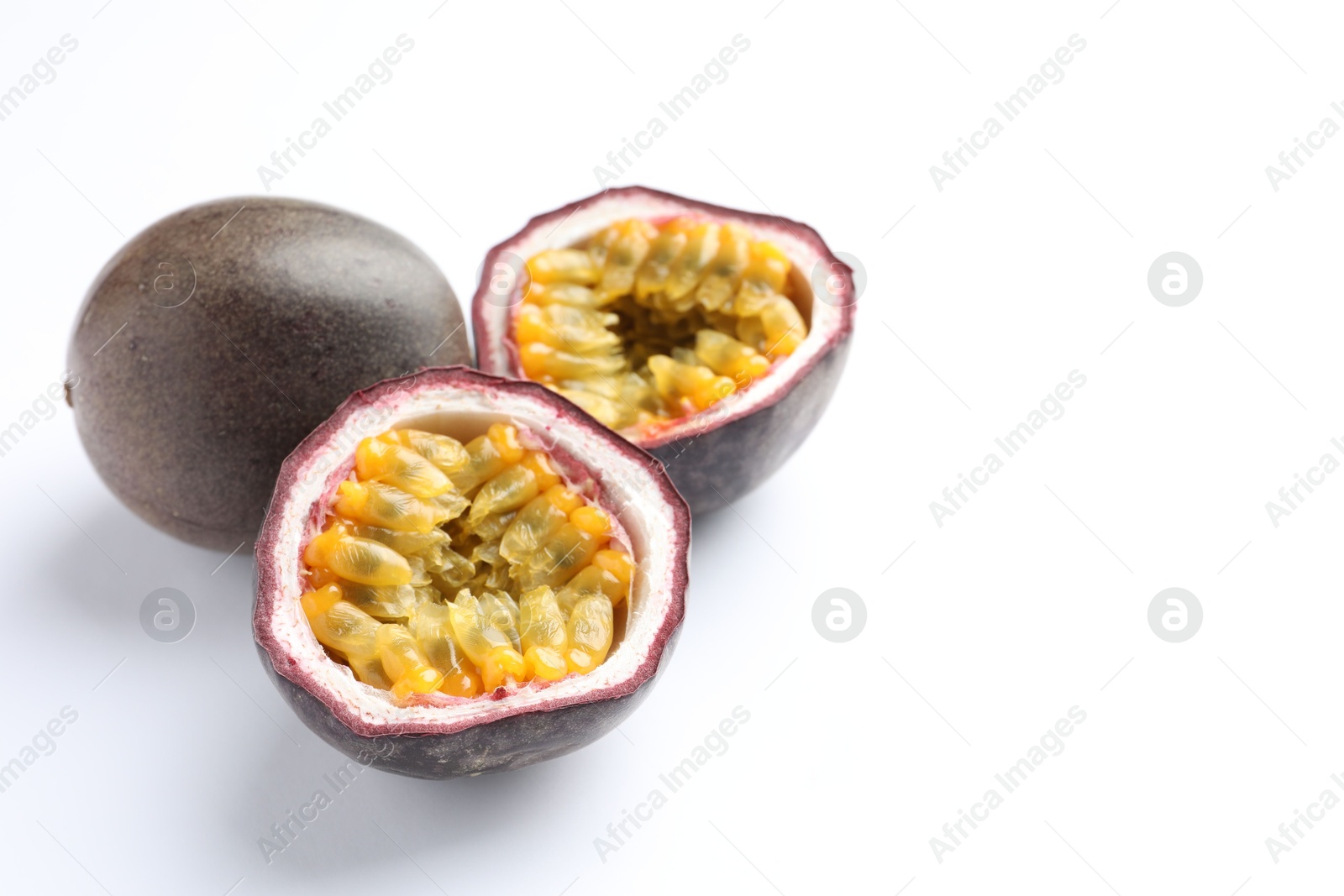 Fresh passion fruits on white background, closeup. Space for text Photo of Fresh passion fruits on white background, closeup. Space for text