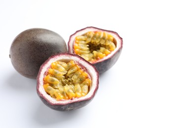 Photo of Fresh passion fruits on white background, closeup. Space for text