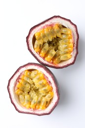 Photo of Halves of fresh passion fruit on white background, top view