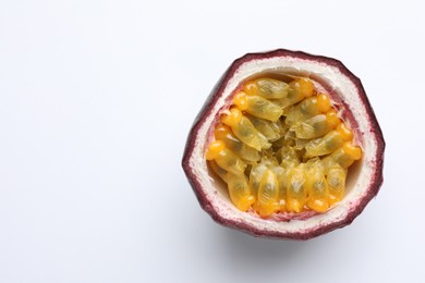 Photo of Half of fresh passion fruit on white background, closeup. Space for text