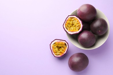 Photo of Fresh passion fruits on violet background, flat lay. Space for text