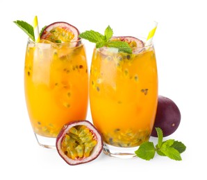 Photo of Tasty passion fruit drink with mint in glasses and fresh fruits isolated on white