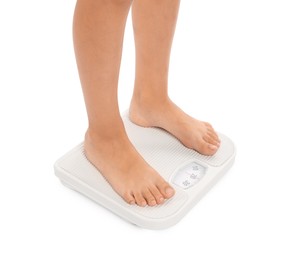 Photo of Little boy standing on scales against white background, closeup
