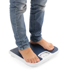 Photo of Little boy standing on scales against white background, closeup