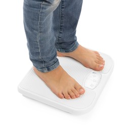 Photo of Little boy standing on scales against white background, closeup