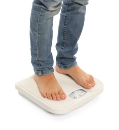 Photo of Little boy standing on scales against white background, closeup