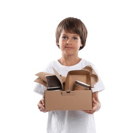 Photo of Recycling. Cute little boy with cardboard box full of different waste paper on white background