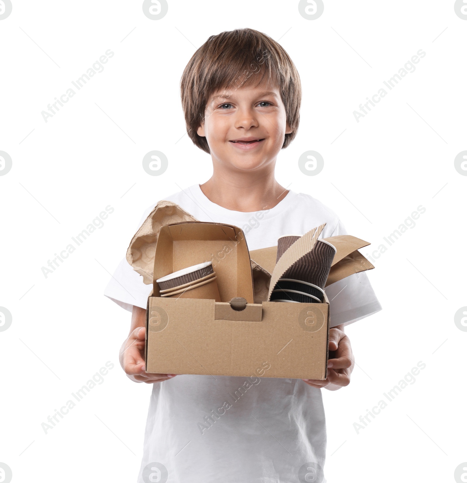 Photo of Recycling. Cute little boy with cardboard box full of different waste paper on white background