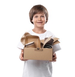Photo of Recycling. Cute little boy with cardboard box full of different waste paper on white background
