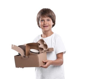 Photo of Recycling. Cute little boy with cardboard box full of different waste paper on white background