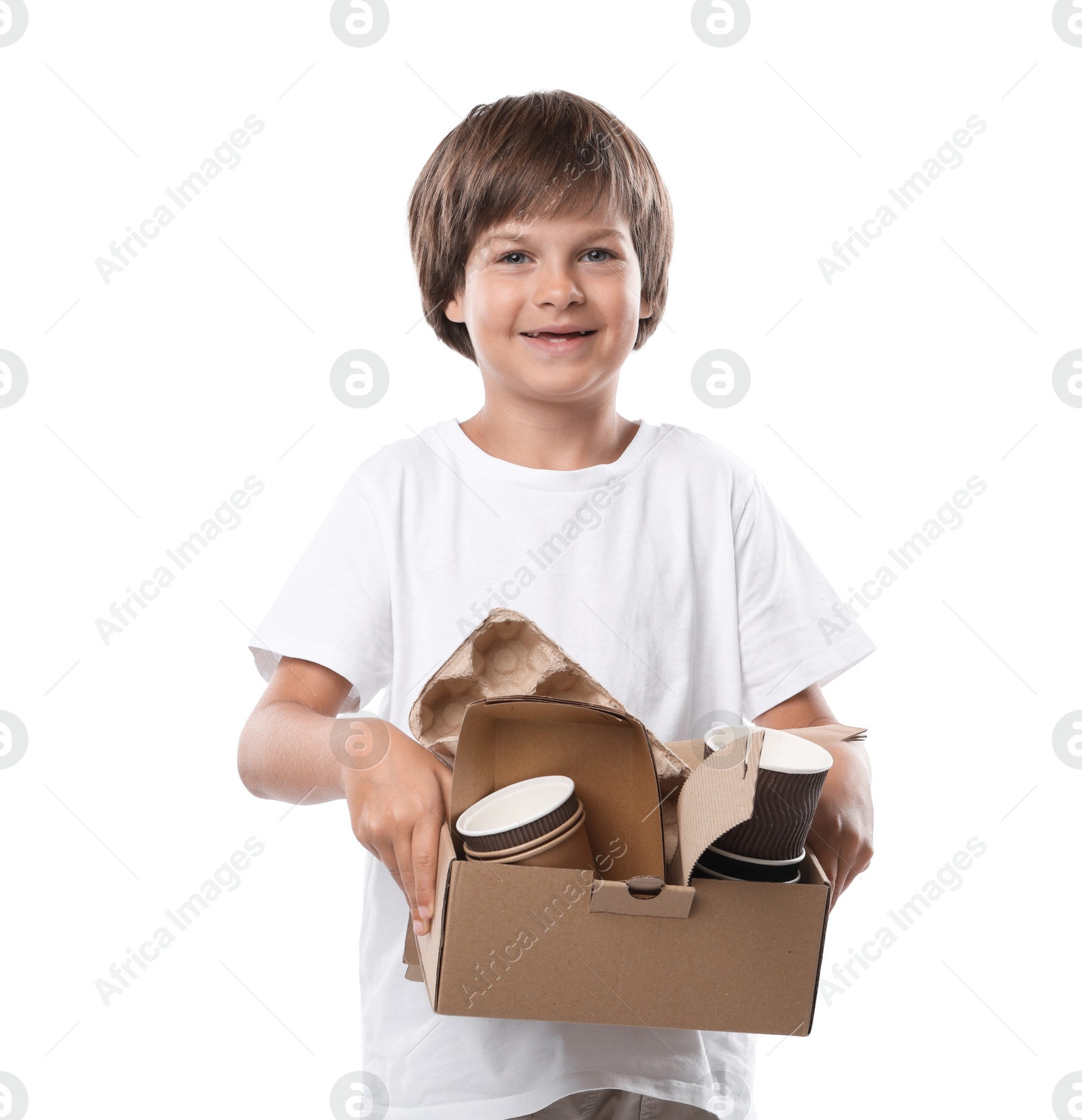 Photo of Recycling. Cute little boy with cardboard box full of different waste paper on white background