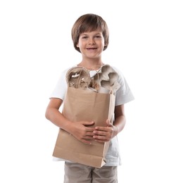 Photo of Recycling. Cute little boy with bag full of different waste paper on white background