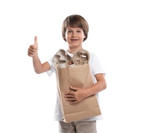 Photo of Recycling. Cute little boy with bag full of different waste paper showing thumbs up on white background