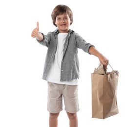 Photo of Recycling. Cute little boy with bag full of different waste paper showing thumbs up on white background
