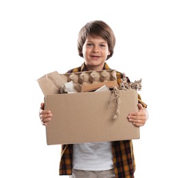 Photo of Recycling. Cute little boy with cardboard box full of different waste paper on white background