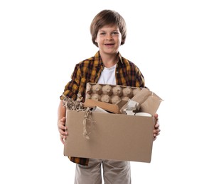 Photo of Recycling. Cute little boy with cardboard box full of different waste paper on white background