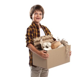 Photo of Recycling. Cute little boy with cardboard box full of different waste paper on white background
