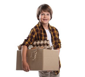 Photo of Recycling. Cute little boy with cardboard box full of different waste paper on white background
