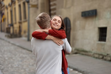 Photo of Goodbye. Lovely couple hugging on city street