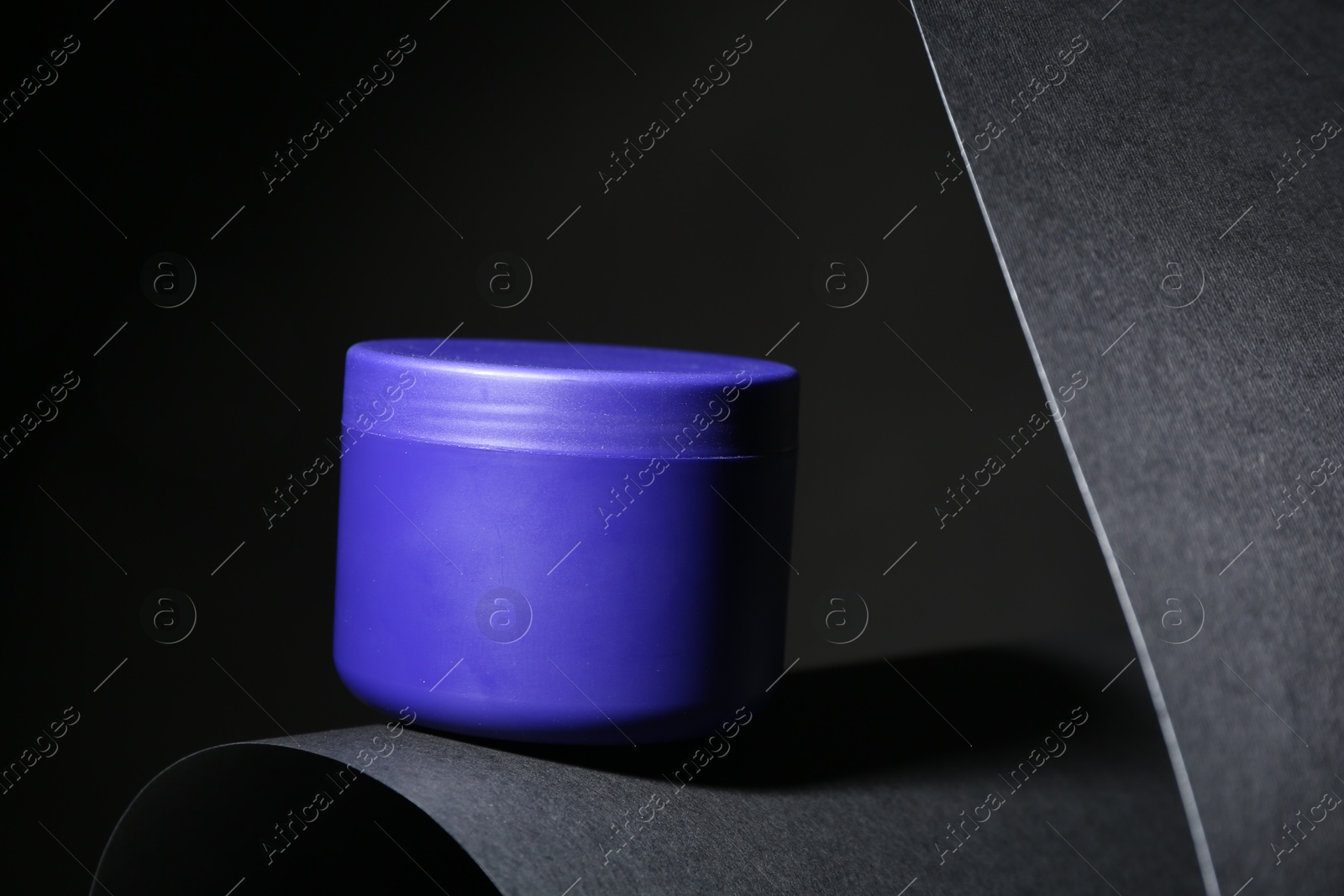 Jar of hair care cosmetic product for blonde hair on black background Photo of Jar of hair care cosmetic product for blonde hair on black background