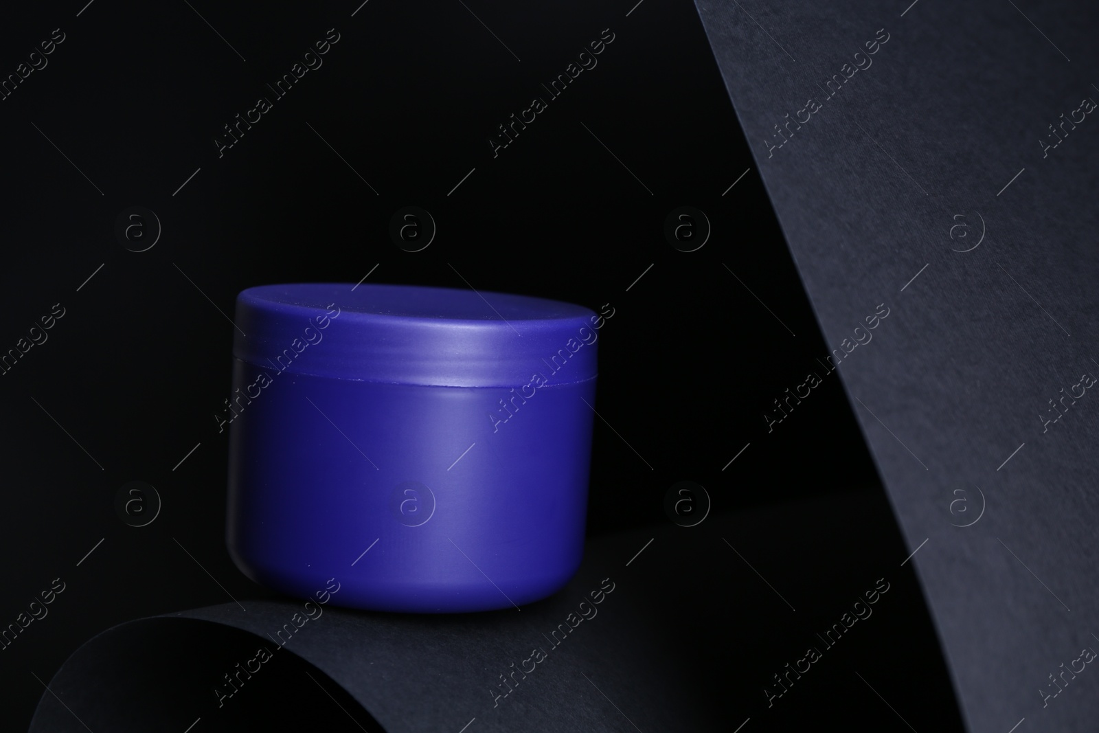 Jar of hair care cosmetic product for blonde hair on black background Photo of Jar of hair care cosmetic product for blonde hair on black background