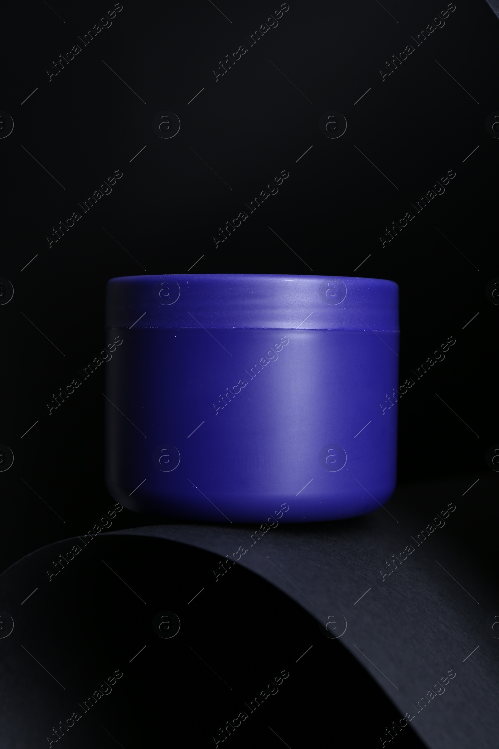 Jar of hair care cosmetic product for blonde hair on black background Photo of Jar of hair care cosmetic product for blonde hair on black background