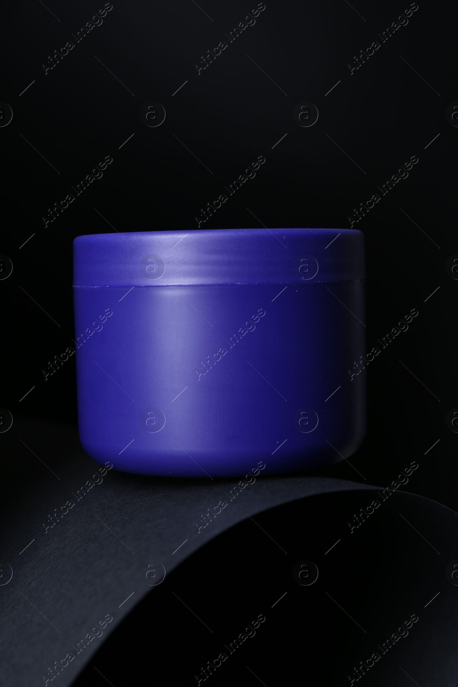 Jar of hair care cosmetic product for blonde hair on black background Photo of Jar of hair care cosmetic product for blonde hair on black background