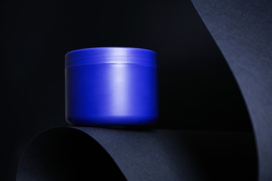 Photo of Jar of hair care cosmetic product for blonde hair on black background