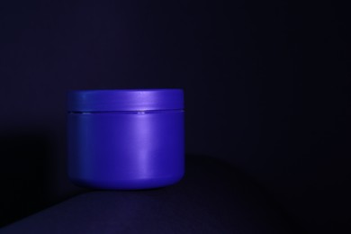 Photo of Jar of hair care cosmetic product for blonde hair on dark background. Space for text