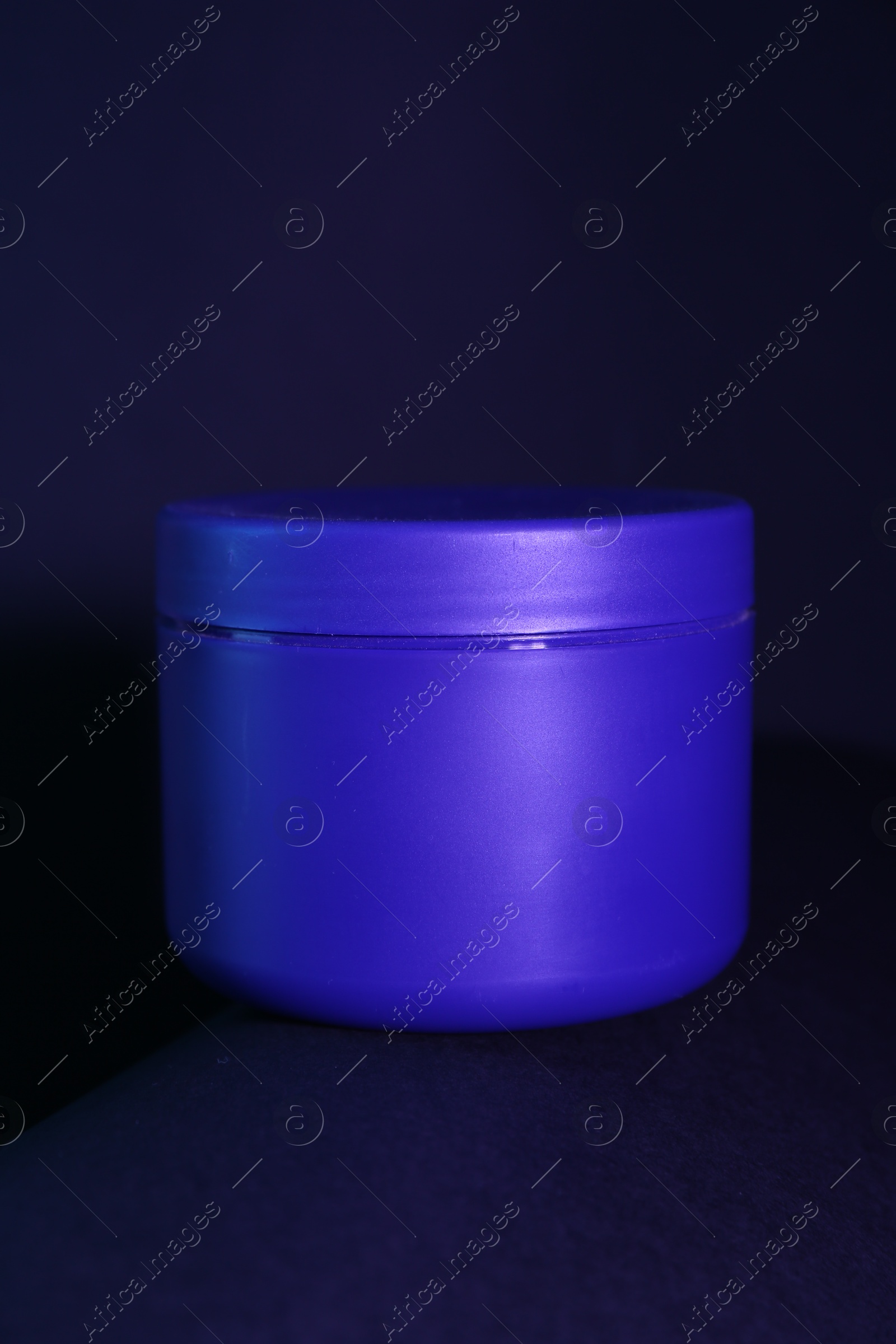 Jar of hair care cosmetic product for blonde hair on dark background, closeup Photo of Jar of hair care cosmetic product for blonde hair on dark background, closeup