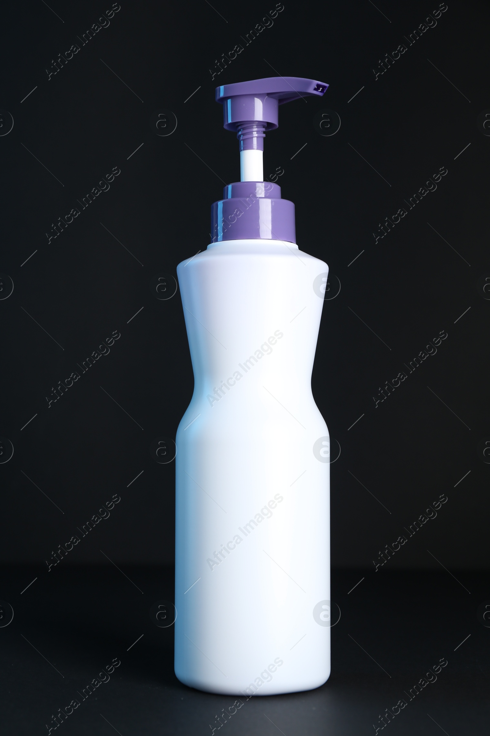 Bottle of hair care cosmetic products for blonde hair on black background Photo of Bottle of hair care cosmetic products for blonde hair on black background