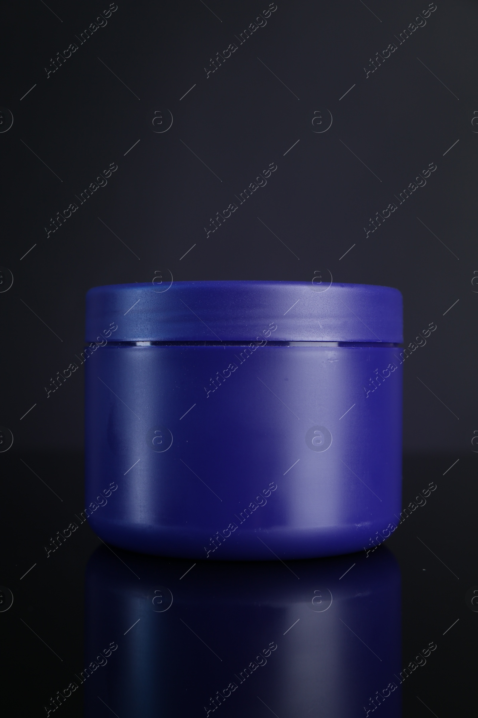 Jar of hair care cosmetic product for blonde hair on dark background Photo of Jar of hair care cosmetic product for blonde hair on dark background