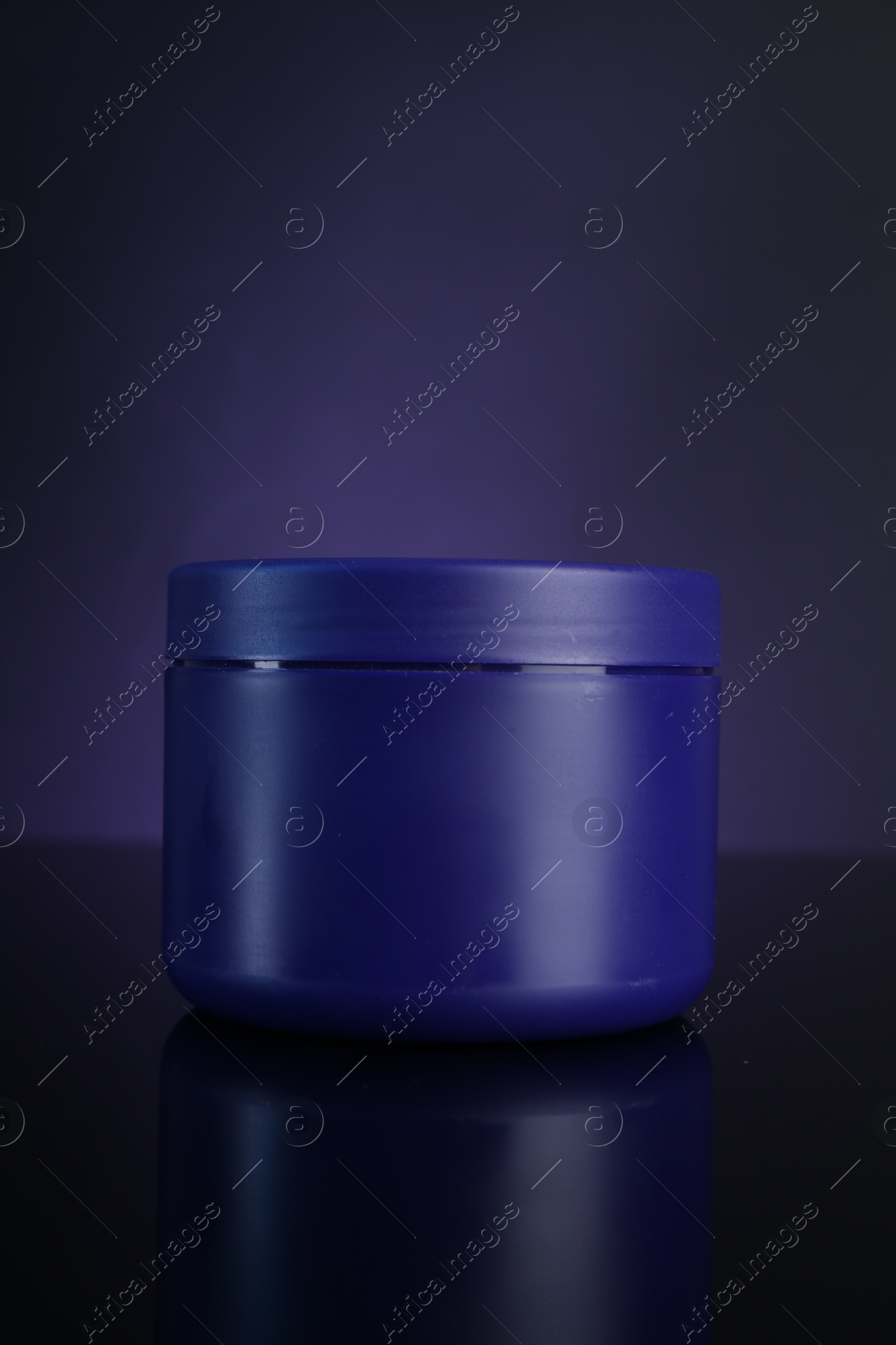 Jar of hair care cosmetic product for blonde hair on dark purple background Photo of Jar of hair care cosmetic product for blonde hair on dark purple background