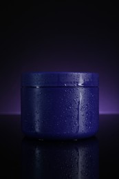 Photo of Jar of hair care cosmetic product for blonde hair on dark purple background
