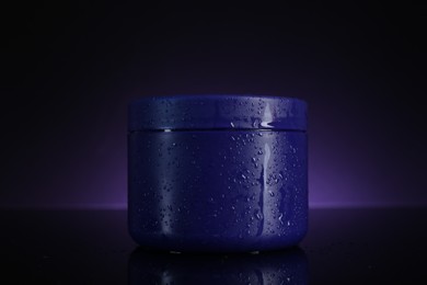 Photo of Jar of hair care cosmetic product for blonde hair on dark purple background