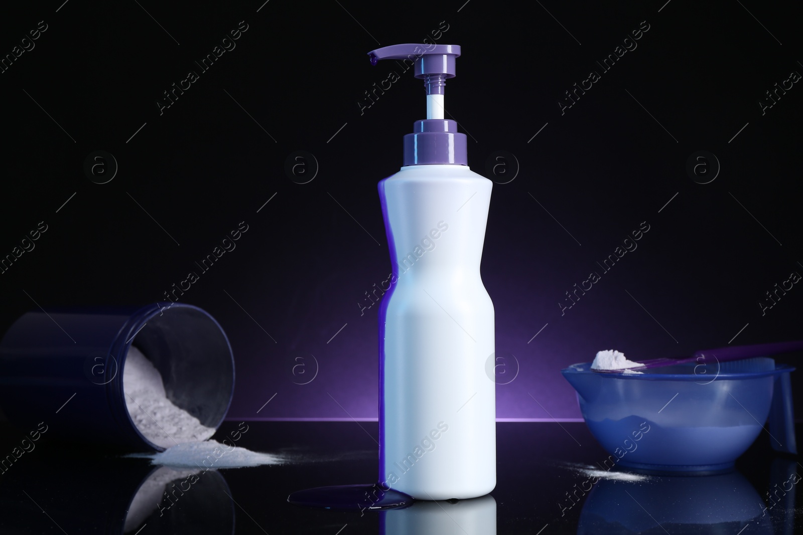 Hair care cosmetic product for blonde hair and powder on black mirror surface against dark purple background Photo of Hair care cosmetic product for blonde hair and powder on black mirror surface against dark purple background