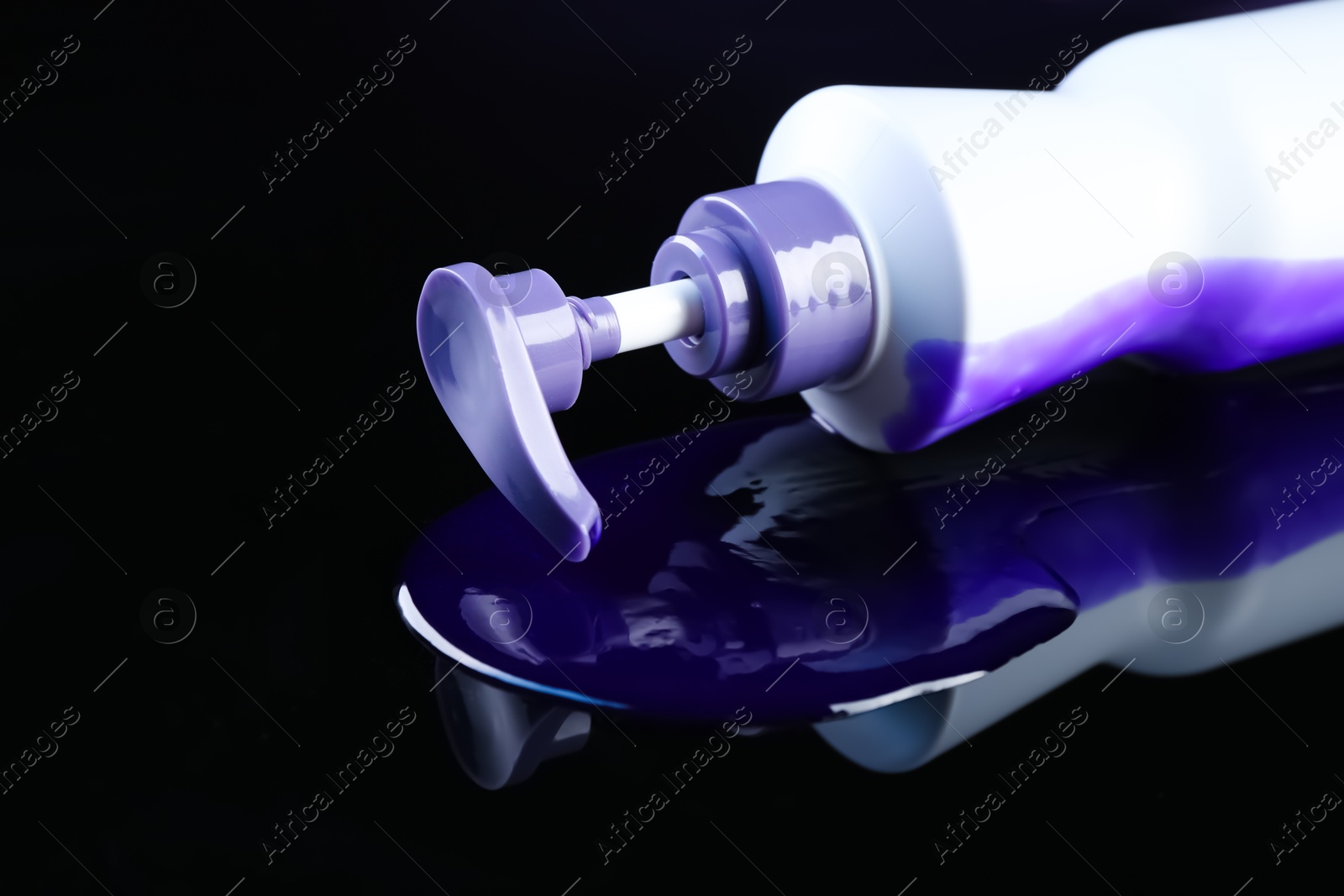 Bottle of hair care cosmetic products for blonde hair on black mirror surface, closeup. Space for text Photo of Bottle of hair care cosmetic products for blonde hair on black mirror surface, closeup. Space for text