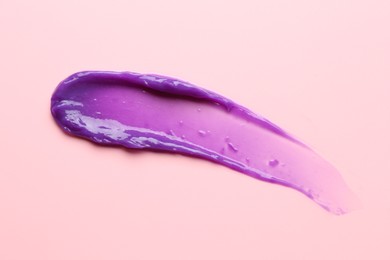 Photo of Sample of blonde hair care cosmetic product on pink background, top view