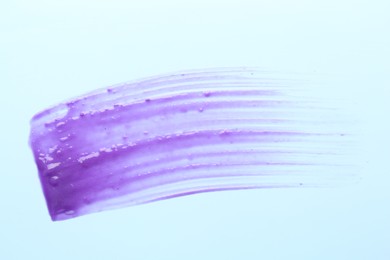 Photo of Sample of blonde hair care cosmetic product on light blue background, top view