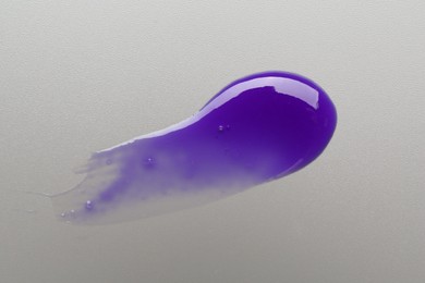 Photo of Sample of blonde hair care cosmetic product on grey background, top view