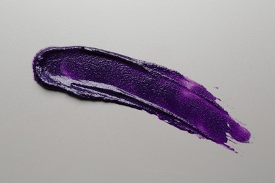 Photo of Sample of blonde hair care cosmetic product on grey background, top view