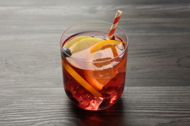 Photo of Fruity punch in glass on wooden table, closeup. Refreshing drink