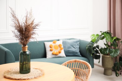 Photo of Wooden table with decor and stylish chair in dining room, closeup