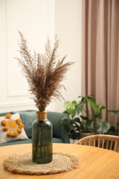 Photo of Wooden table with decor and stylish chair in dining room, closeup