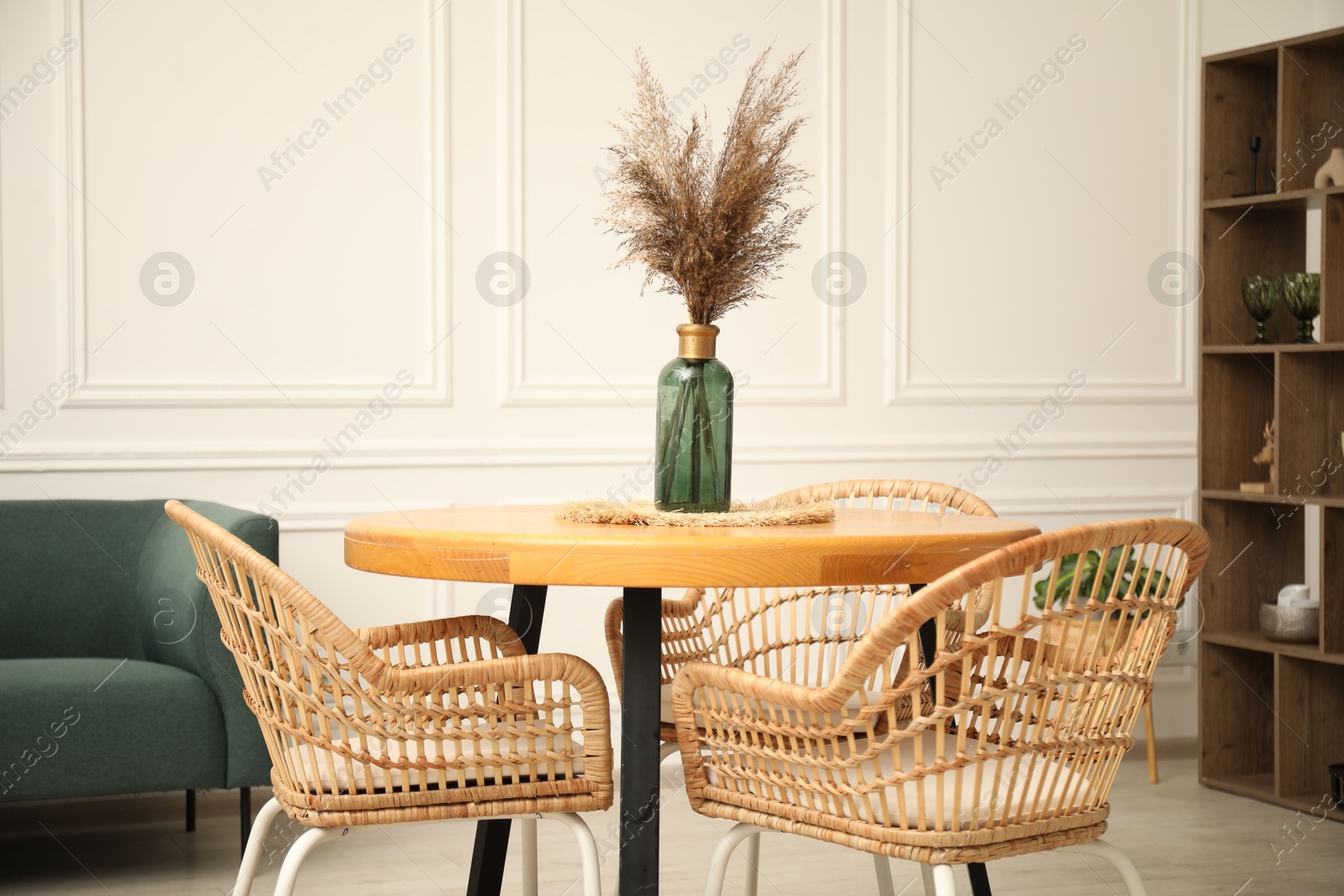Wooden table with decor and stylish chairs in dining room Photo of Wooden table with decor and stylish chairs in dining room