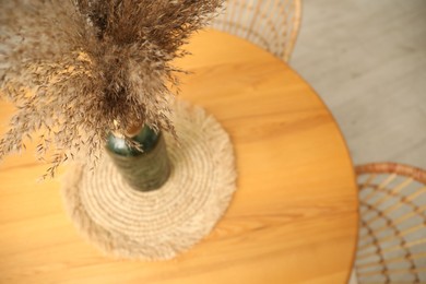 Photo of Wooden table with decor and stylish chairs in dining room, above view