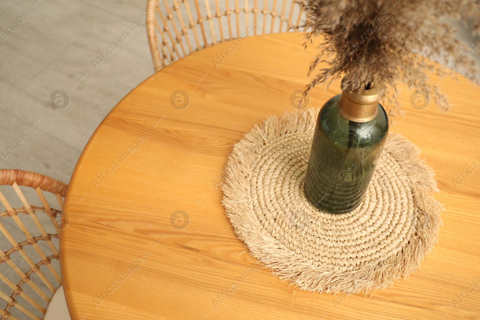 Wooden table with decor and stylish chairs in dining room, above view Photo of Wooden table with decor and stylish chairs in dining room, above view